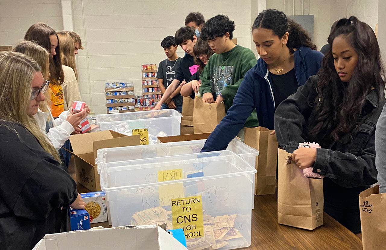 Cicero-North Syracuse HS seniors pack food bags for district families as part of their Participation in Government class.