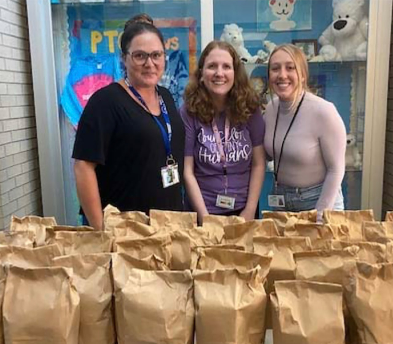From left, North Syracuse EA members Jessica Nabewaniec, Kerry  Delduchetto and Rachel Prikazsky receive a delivery at a local school.