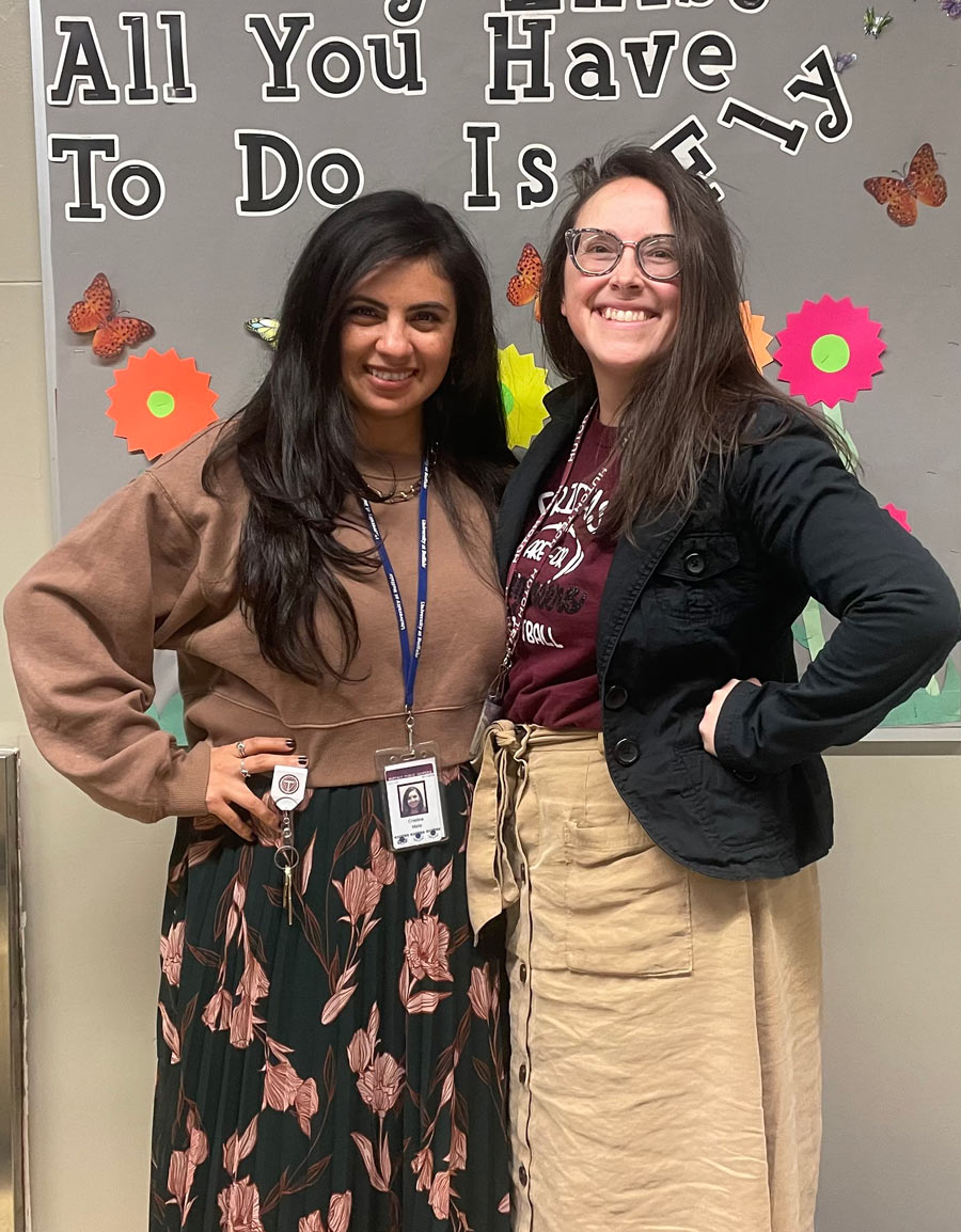 Cristina Mata and Kacy Wandel smiling for a picture in a classroom