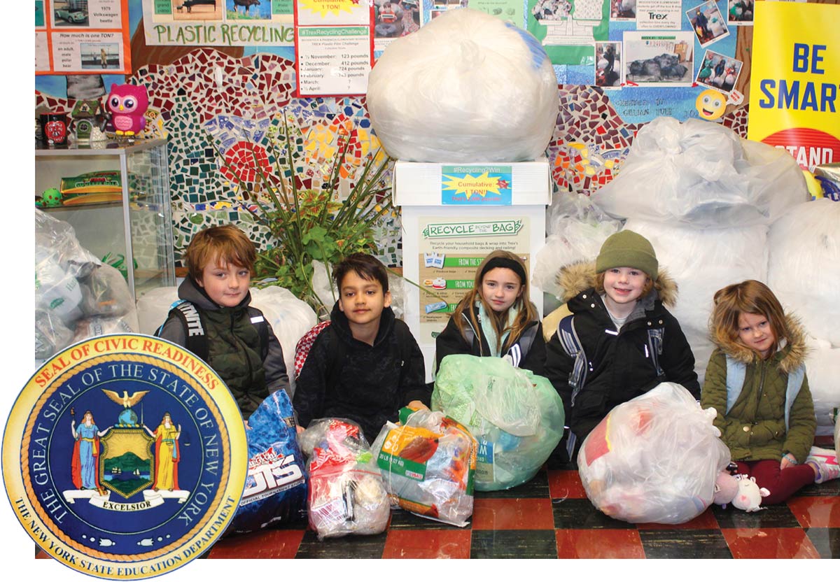 Onteora elementary students sitting on a classroom floor holding bags of polyethylene plastic, the Seal of Civic Readiness floats in the left corner