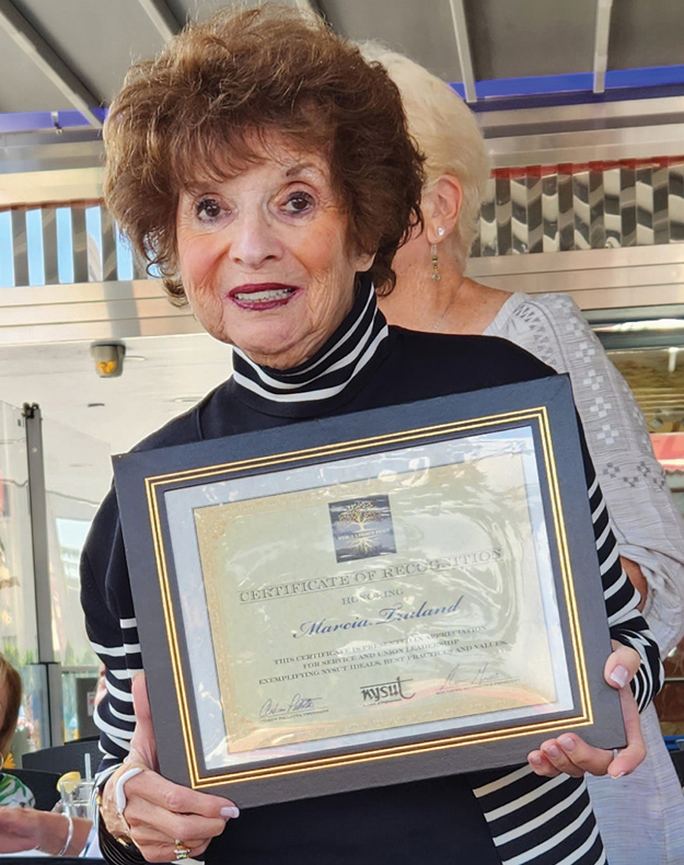 Marcia Truland holding her Certificate of Recognition