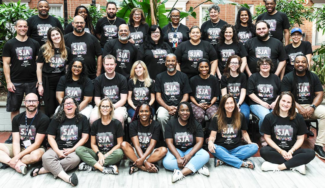 the inaugural class of the NYSUT Social Justice Academy take a large group photo, all wearing the NYSUT Social Justice Academy t-shirt