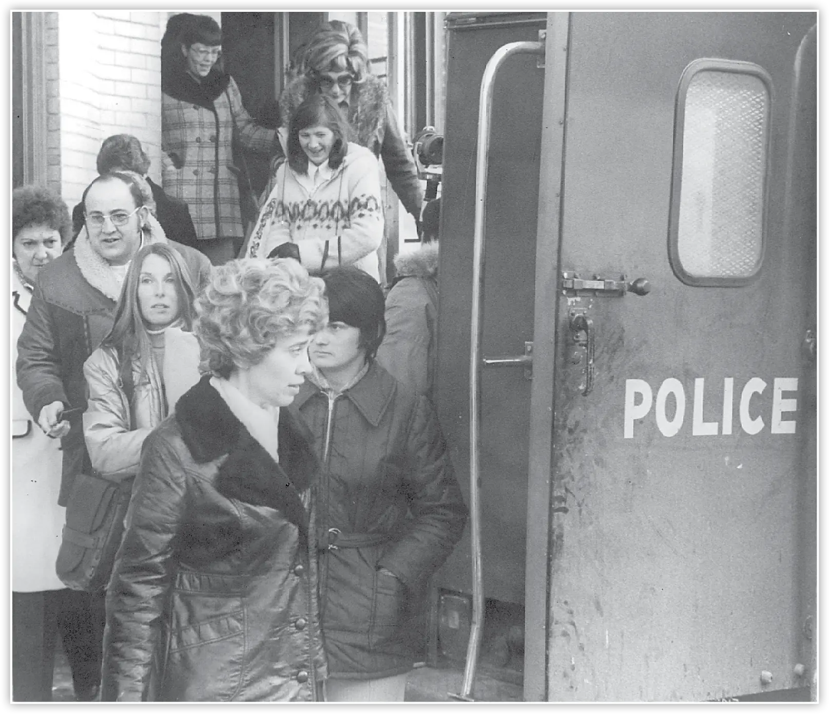 Schenectady teachers line up to board a police wagon heading to jail