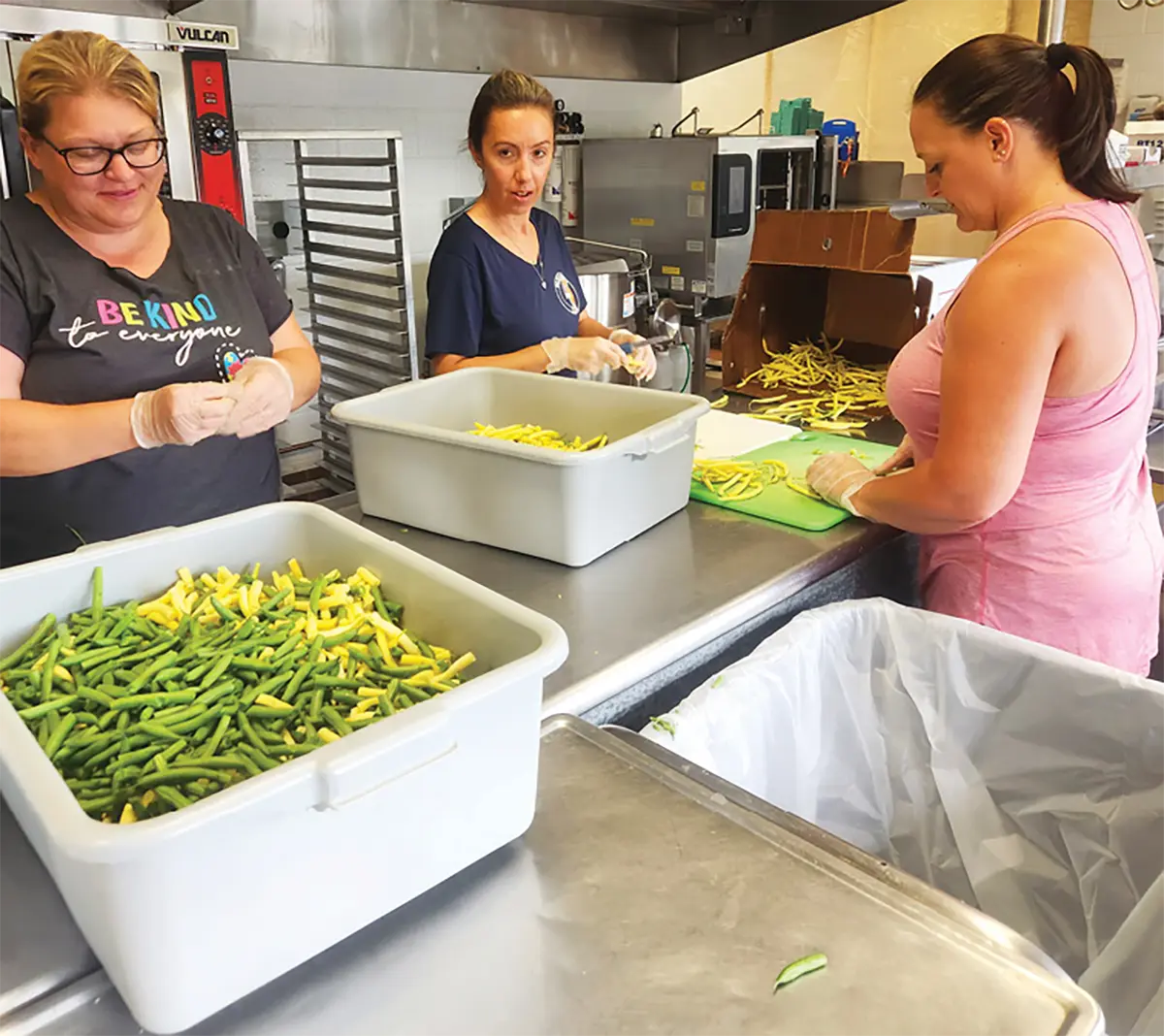 Attica Central School District team members, from left, Melissa Brooks, Amanda Brown and Jenelle Bauer help break down and preserve produce from local farms for school meals. The team prepped green beans, corn, berries and more. 