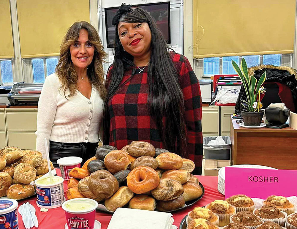 Staff in lounge with large platter of bagels
