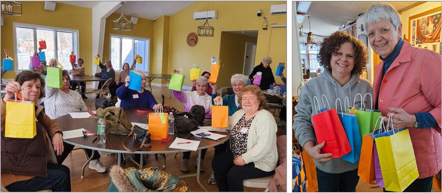 seniors sitting at tables in a community center hold up winter wellness packages in different colored bags; BTA PR Committee co-chair Sara Goetschkes smiles while holding different colored gift bags and standing beside Edie Devito