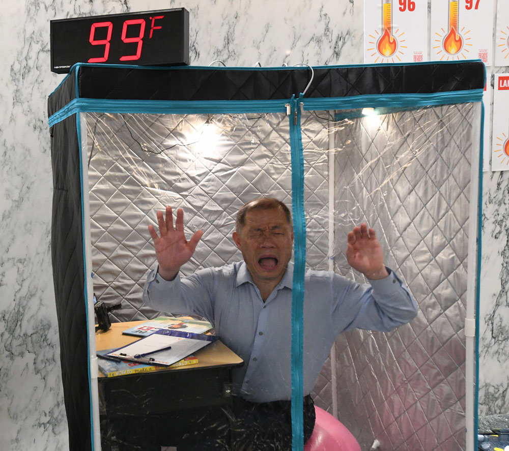 Sen. John Liu inside of portable sauna tent