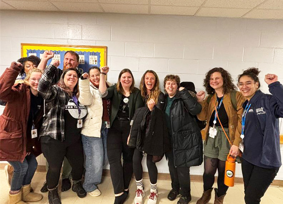 group of people holding their fist up