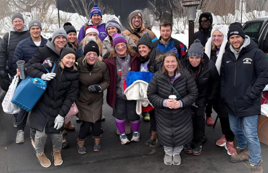 Members of the Hamburg TA smiling for group photo outside in coats