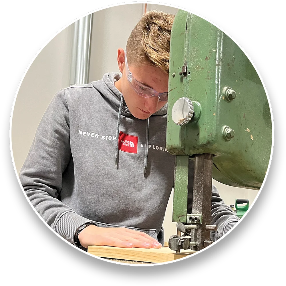 Person operating a bandsaw machine.