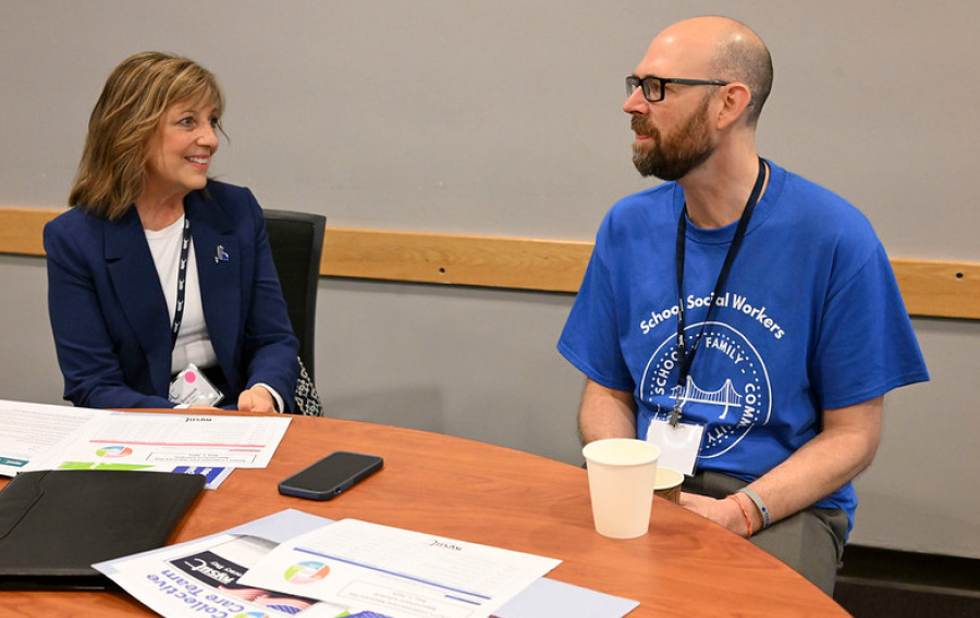 Mary Banaszak and James Garner sitting at table talking at NYSUT’s Collective Care Lobby Day