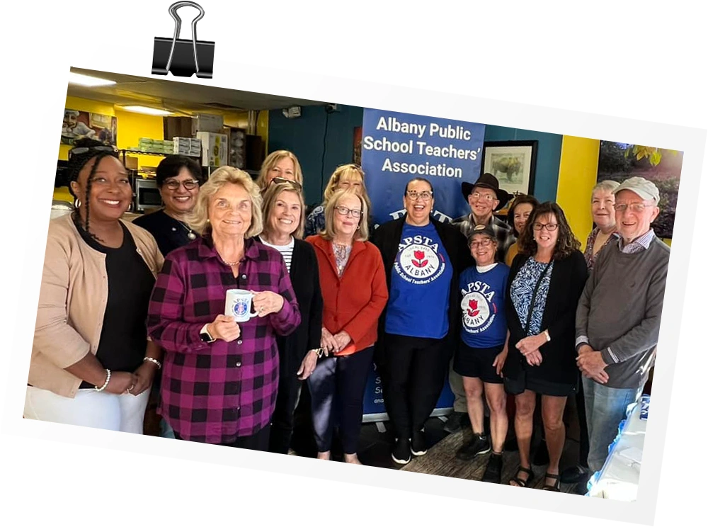 Albany retirees take an indoor group photo in an association building