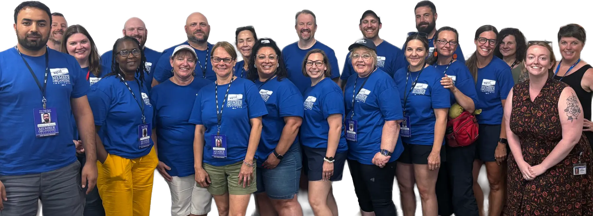 A diverse group of educators and union members in blue shirts with "Member Institute" badges smile for a group photo.