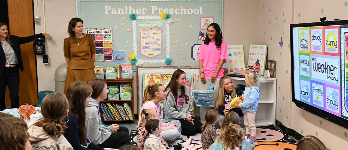 Melinda Person, NYSUT President, observes high school students teaching children in the Babylon High School Panther Preschool.