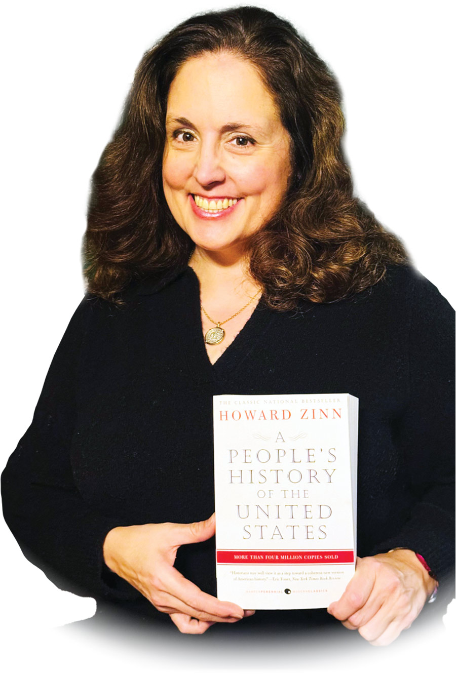 Josephine O'Conner, a smiling woman with dark long brown hair, a black blouse top, and a gold pendant necklace is seen holding a copy of the book titled A People's History of the United States by Howard Zinn