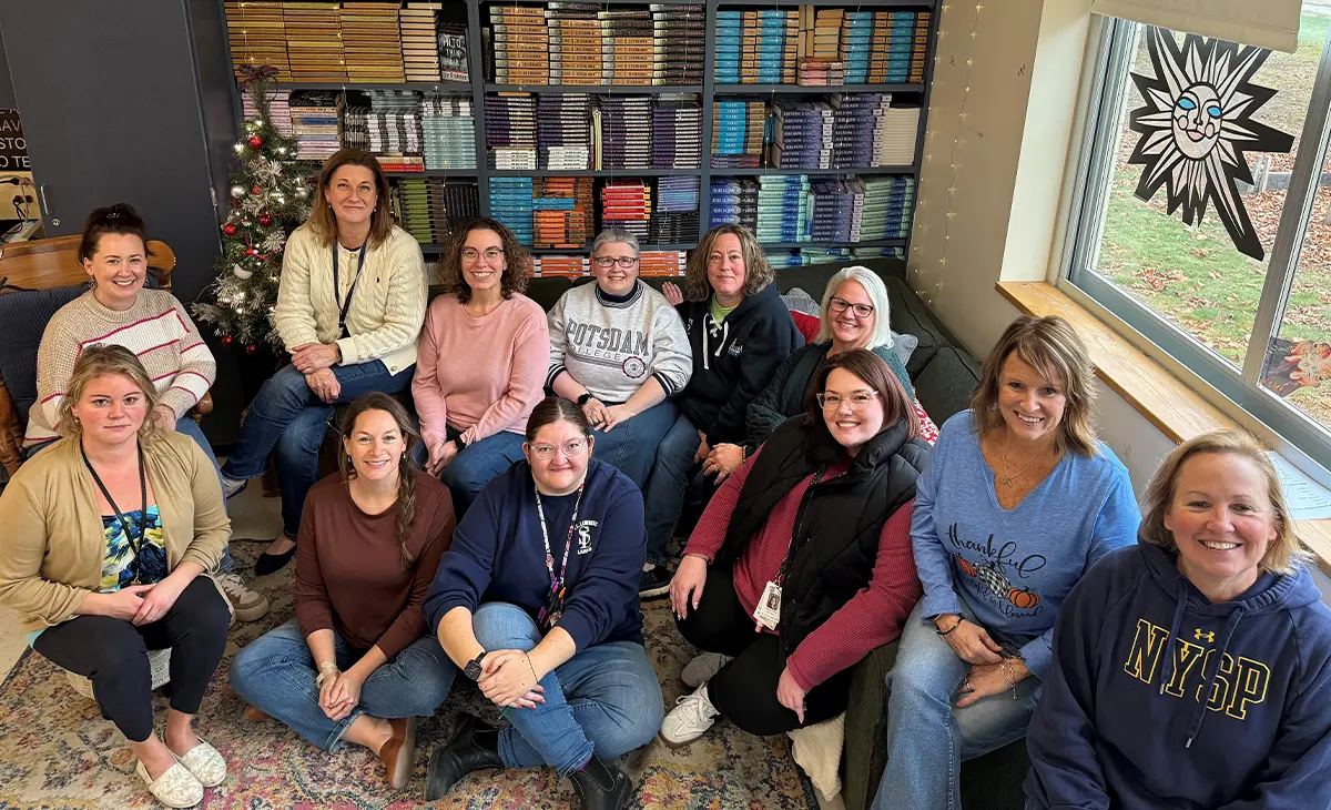 Group of teachers posing together in a classroom