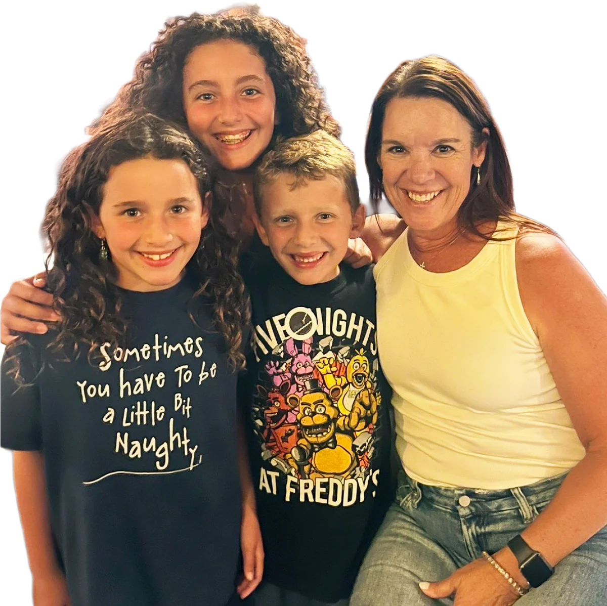 A smiling woman poses tightly together with three happy children, against a plain white background.