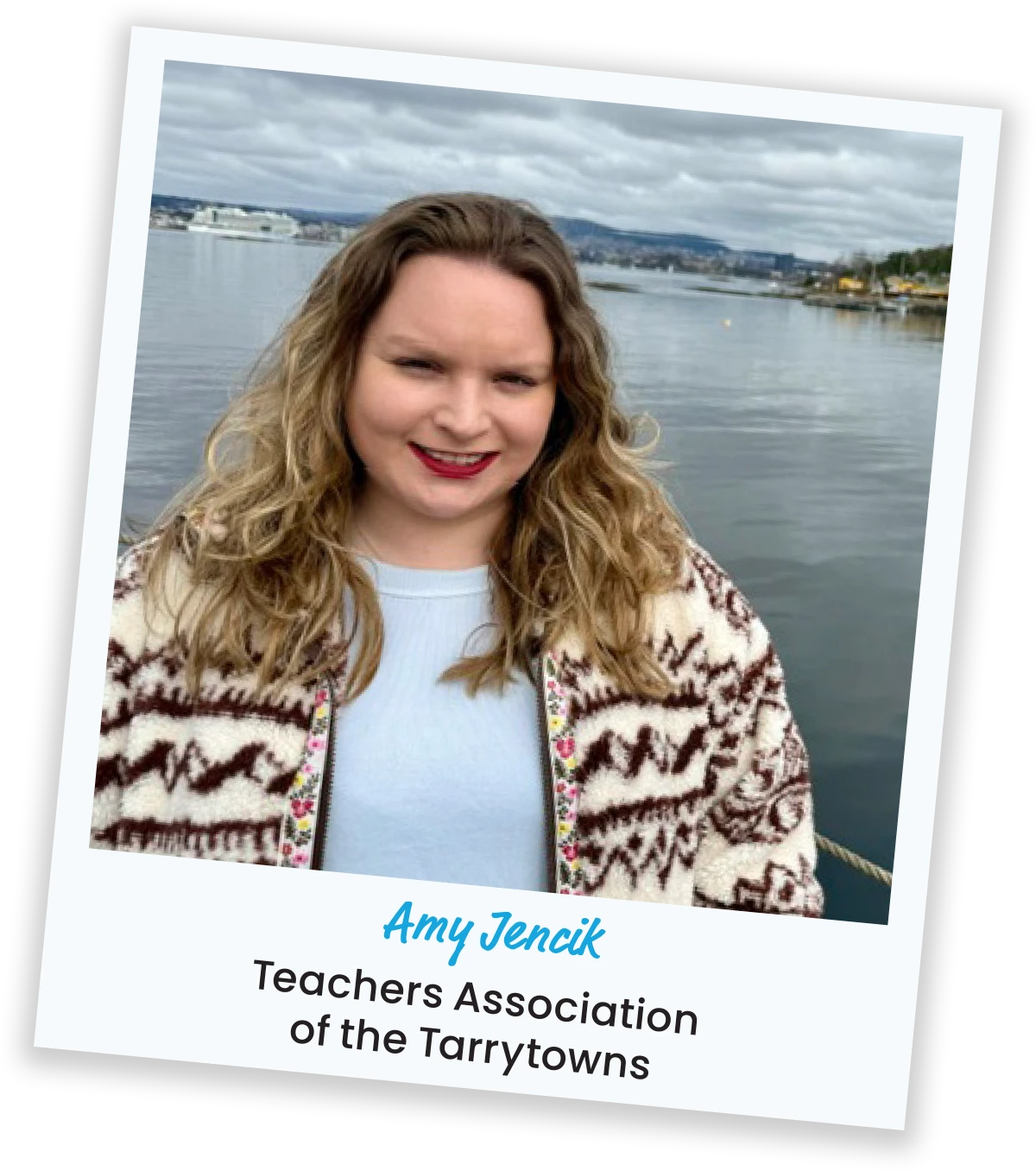 Portrait of Amy Jencik from Teachers Association of the Tarrytowns smiling outdoors in front of a body of water.